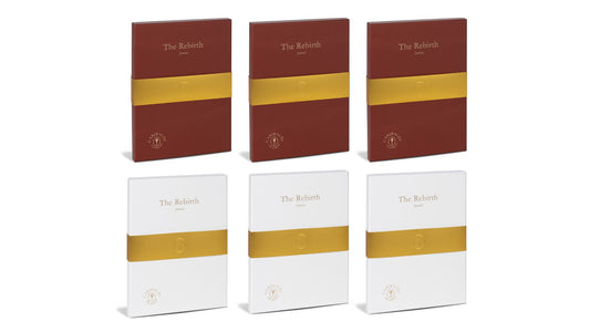 Set of six journal boxes titled 'The Rebirth' with gold bands on a white background